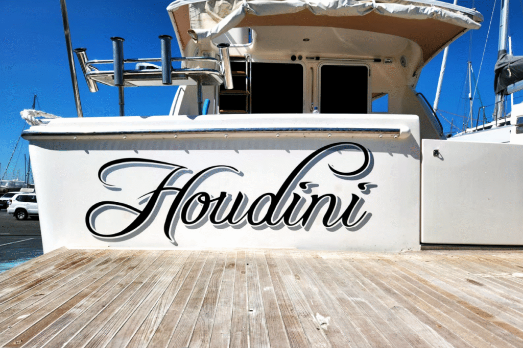 Transom Boat ID 2D Name Boat signage & graphics: Your questions answered 9 Photo of luxury yacht displaying vinyl boat name graphic Houdini in cursive font