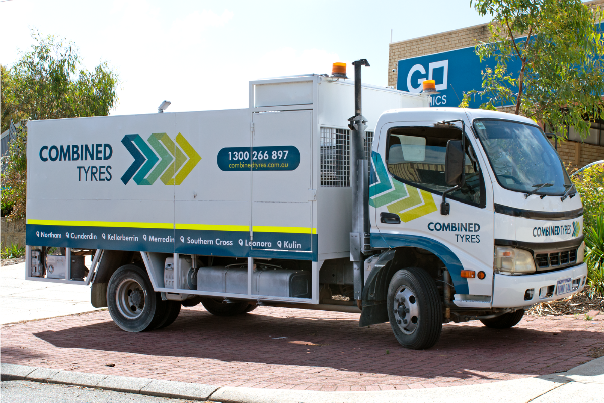 Mine spec Signage Perth Combined Tyres Mine Spec Signage Perth 8 Combined Tyres truck parked outside warehouse displaying vehicle graphics and mine site safety signage