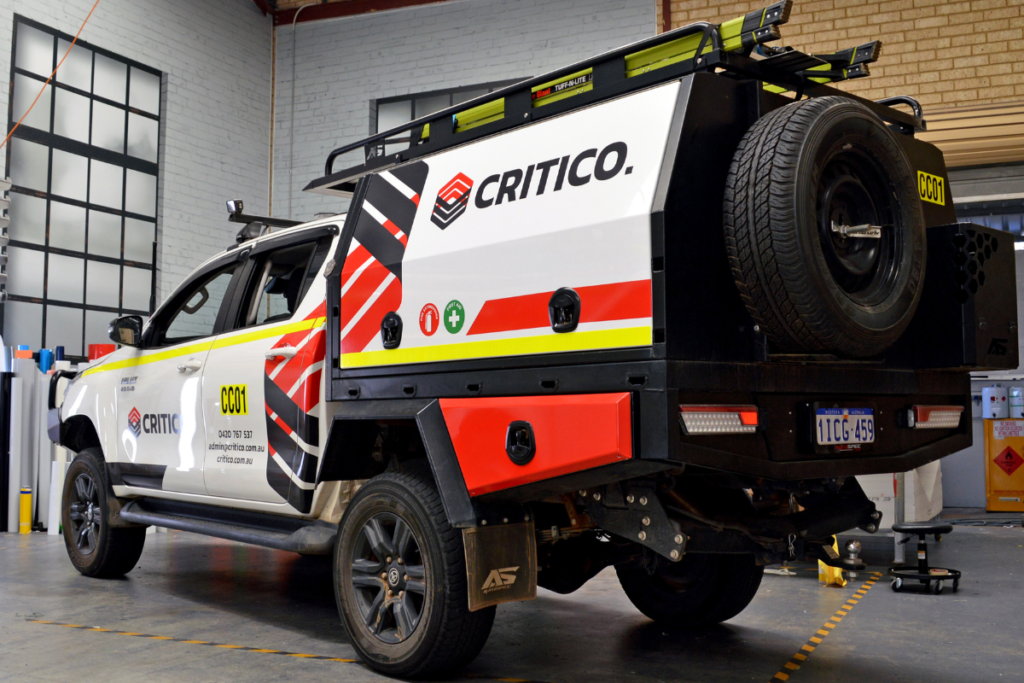 Mine spec Signage Perth Critico MINE SPEC DOESN’T HAVE TO BE BORING: WHEN COMPLIANCE MEETS BRANDING 1 Cranecorp utes lined up outside workshop displaying branding vehicle graphics with mine spec signage
