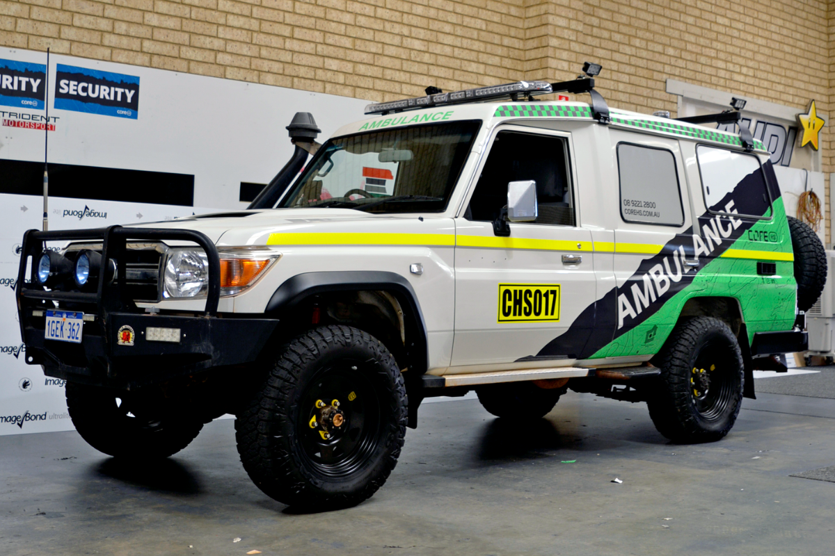 Mine spec Signage Perth Ambulance Mine Spec Signage Perth 14 4wd ambulance parked in warehouse displaying mine site compliant signage and branding graphics