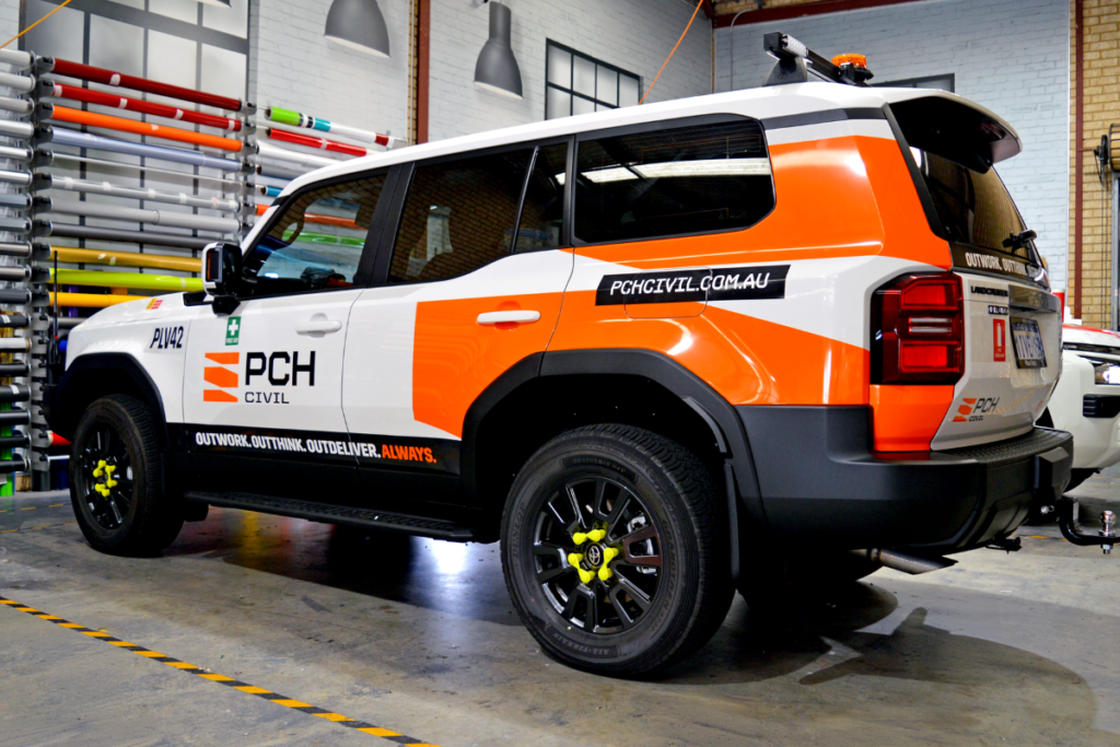 Mine spec Signage Perth PCH MINE SPEC DOESN’T HAVE TO BE BORING: WHEN COMPLIANCE MEETS BRANDING 5 PCH 4wd parked in warehouse displaying mine spec safety signage and branded vehicle graphics