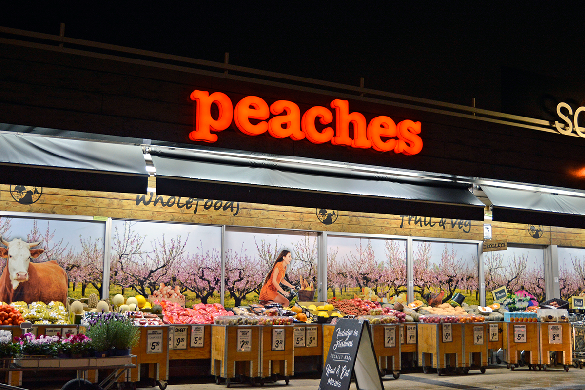Peaches Shopfront Signage Perth Go Graphics Commercial Signage 3 exterior shot of Peaches retail store in South Fremantle displaying illuminated exterior building signage at night