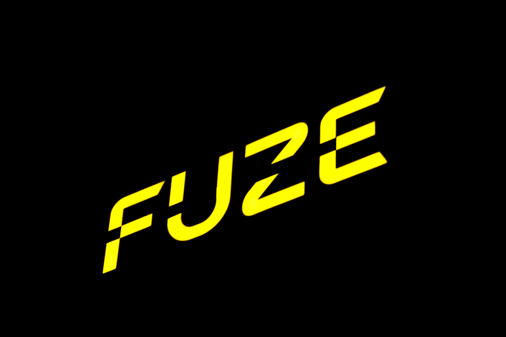 Exterior of commercial Perth building at night showing FUZE illuminated sign logo lit up