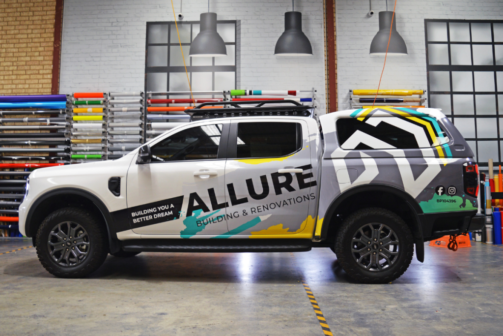 Vehicle Signage Go Graphics Allure VEHICLE SIGNAGE: YOUR QUESTIONS ANSWERED 6 Ute with cab parked inside Go Graphics Workshop displaying Allure branding across partial vehicle wrap