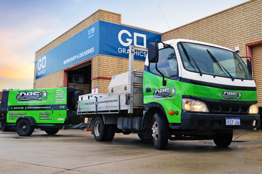 Vehicle Signage Go Graphics Dustless Blasting VEHICLE SIGNAGE: YOUR QUESTIONS ANSWERED 2 Truck and trailer parked outside Go Graphics workshop showcasing vibrant green branding of Dustless Blasting vehicle graphics as full truck wrap and trailer wrap